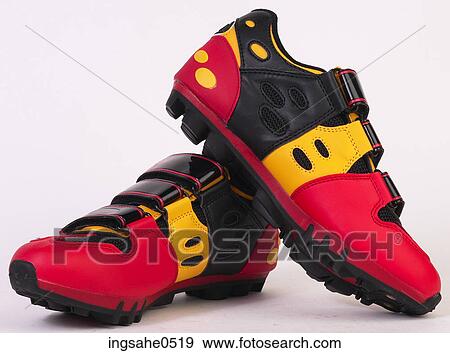 Stock Photo - Red and yellow biking shoes L1. Fotosearch