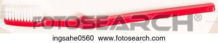 Stock Image - Red plastic toothbrush L2. Fotosearch