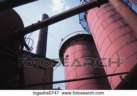 Red rusty metal smokestacks of factory building View Large Photo Image Stock Photo - Red rusty metal smokestacks of factory building . Fotosearch