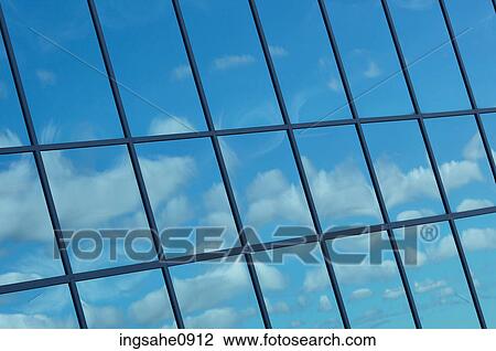 Reflection of blue sky in glass windows of building View Large Photo Image Stock Image - Reflection of blue sky in glass windows of building. Fotosearch