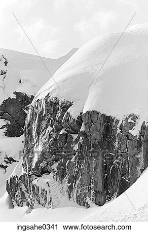 Rock cliff covered with snow View Large Photo Image Stock Image - Rock cliff covered with snow . Fotosearch