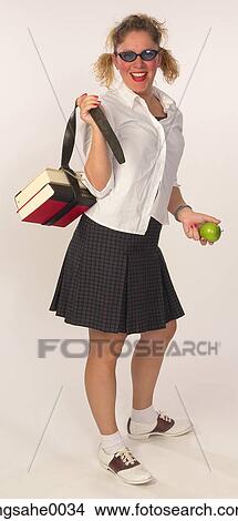 Schoolgirl with green apple 1 View Large Photo Image Picture - Schoolgirl with green apple 1. Fotosearch
