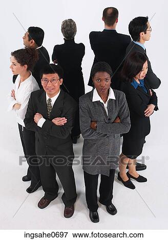 Serious group of businesspeople standing back to back View Large Photo Image Stock Photo - Serious group of businesspeople standing back to back. Fotosearch