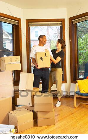 Smiling couple moving boxes out of empty apartment 1 View Large Photo Image Stock Image - Smiling couple moving boxes out of empty apartment 1. Fotosearch