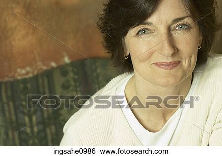 Stock Photograph - Smiling woman in white sweater 1. Fotosearch