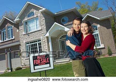 Smiling young couple in front of their new home 2 View Large Photo Image Stock Image - Smiling young couple in front of their new home 2. Fotosearch