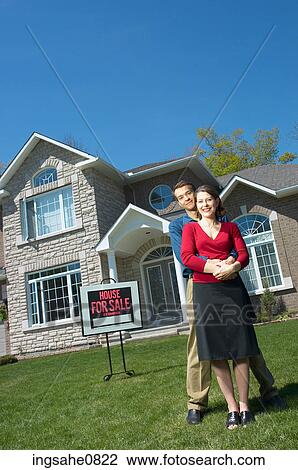 Smiling young couple in front of their new home 3 View Large Photo Image Stock Image - Smiling young couple in front of their new home 3. Fotosearch