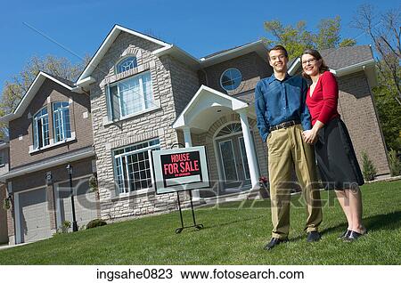 Smiling young couple in front of their new home 4 View Large Photo Image Stock Image - Smiling young couple in front of their new home 4. Fotosearch