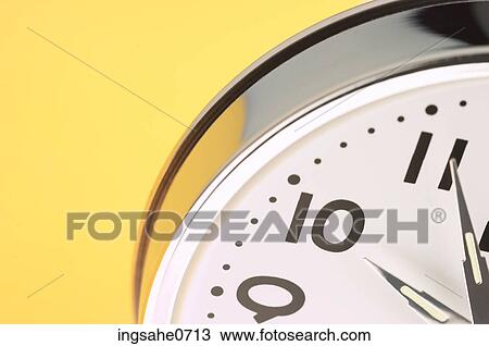 Stainless steel clock on yellow surface View Large Photo Image Stock Image - Stainless steel clock on yellow surface. Fotosearch