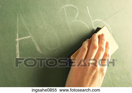 Teacher erasing alphabet off chalkboard View Large Photo Image Stock Photography - Teacher erasing alphabet off chalkboard. Fotosearch