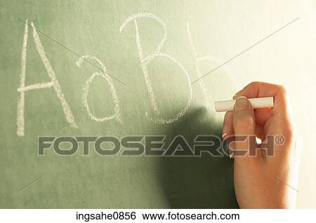 Teacher writing alphabet on chalkboard View Large Photo Image Stock Photograph - Teacher writing alphabet on chalkboard. Fotosearch