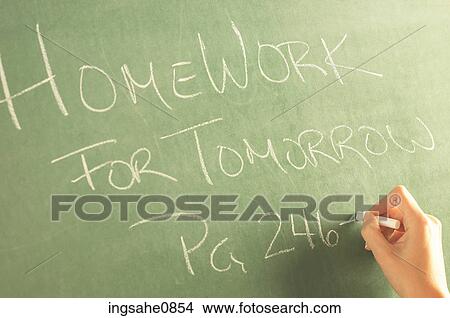 Teacher writing homework on green chalkboard 2 View Large Photo Image Picture - Teacher writing homework on green chalkboard 2. Fotosearch