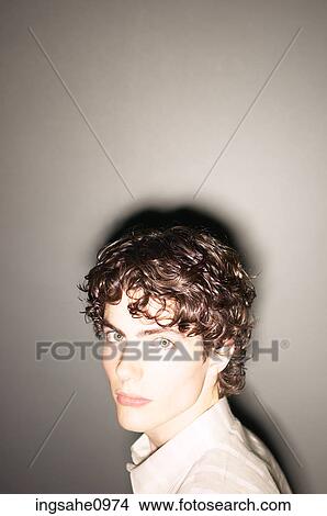 Teenaged boy against wall with shining light View Large Photo Image Picture - Teenaged boy against wall with shining light. Fotosearch