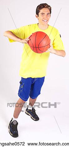 Teenager throwing basketball View Large Photo Image Stock Image - Teenager throwing basketball . Fotosearch