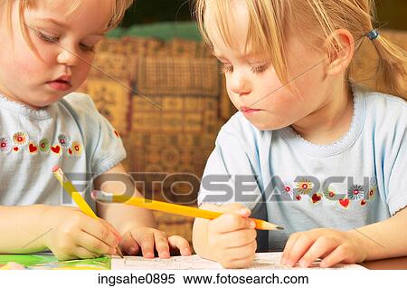 Twin little girls drawing a picture View Large Photo Image Stock Photography - Twin little girls drawing a picture. Fotosearch