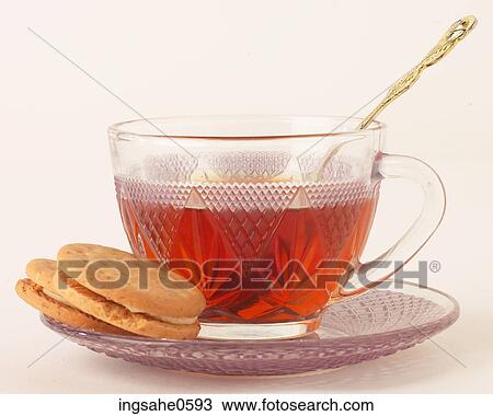 Vanilla cookies beside glass cup of tea View Large Photo Image Stock Image - Vanilla cookies beside glass cup of tea. Fotosearch