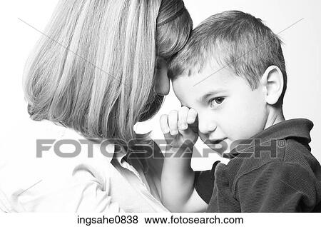 Woman holding tired little boy View Large Photo Image Stock Photo - Woman holding tired little boy. Fotosearch