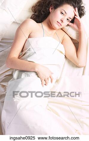 Woman lying in white bed sheets 2 View Large Photo Image Stock Photography - Woman lying in white bed sheets 2. Fotosearch