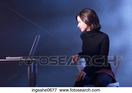 Stock Photo - Woman watching laptop computer. Fotosearch