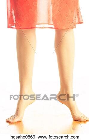 Woman's bare tiptoe feet in orange skirt 3 View Large Photo Image Stock Photo - Woman's bare tiptoe feet in orange skirt 3. Fotosearch
