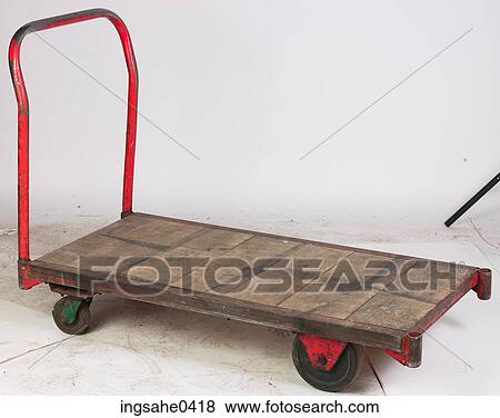 Wooden and red metal dolly View Large Photo Image Stock Photo - Wooden and red metal dolly. Fotosearch