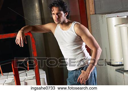 Workman leaning on red forklift View Large Photo Image Stock Image - Workman leaning on red forklift. Fotosearch