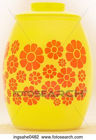 Stock Image - Yellow glass jar with painted orange flowers L3. Fotosearch