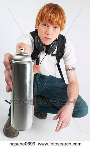 Stock Photo - Youth holding spray paint can. Fotosearch