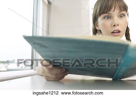 Amazed little girl reading book in classroom View Large Photo Image Stock Image - Amazed little girl reading book in classroom. Fotosearch