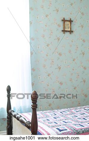 Bedroom with patterned wallpaper and a quilt on the bed View Large Photo Image Stock Image - Bedroom with patterned wallpaper and a quilt on the bed . Fotosearch