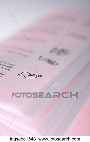 Bow through heart on pink paper View Large Photo Image Stock Photo - Bow through heart on pink paper . Fotosearch