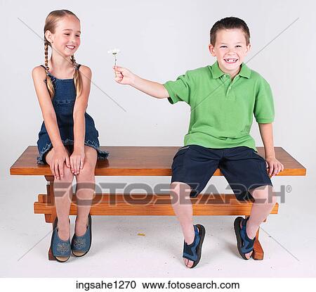 Boy giving girl flower View Large Photo Image Stock Image - Boy giving girl flower . Fotosearch