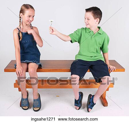 Boy giving girl flower View Large Photo Image Stock Image - Boy giving girl flower . Fotosearch