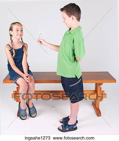 Stock Image - Boy giving girl flower . Fotosearch