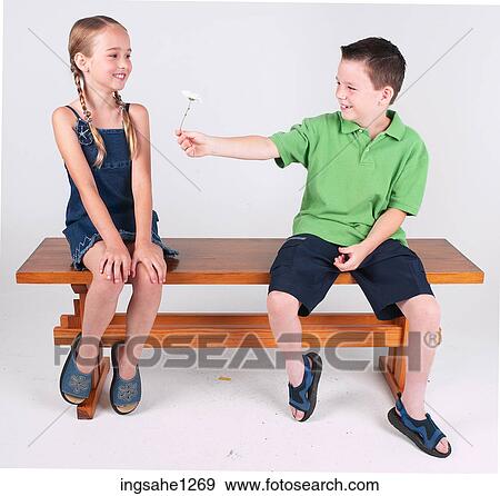 Boy giving girl flower View Large Photo Image Stock Photo - Boy giving girl flower . Fotosearch