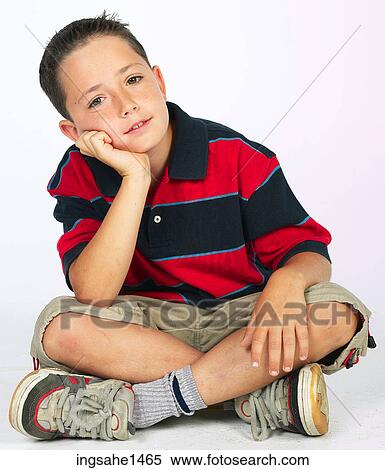 Stock Photography - boy sitting on ground . Fotosearch