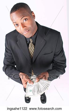 Stock Image - Businessman holding money a82. Fotosearch