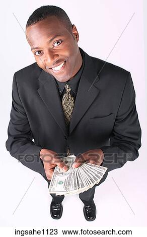 Businessman holding money a83 View Large Photo Image Stock Image - Businessman holding money a83. Fotosearch