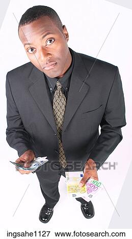 Stock Photo - Businessman holding money a87. Fotosearch