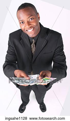 Stock Photo - Businessman holding money a88. Fotosearch