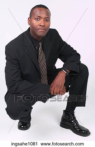 Businessman squatting a81 View Large Photo Image Stock Image - Businessman squatting a81. Fotosearch