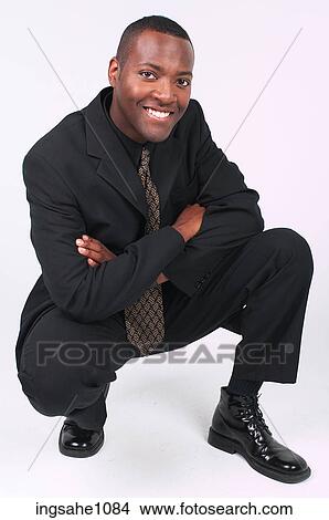 Businessman squatting a83 View Large Photo Image Picture - Businessman squatting a83. Fotosearch