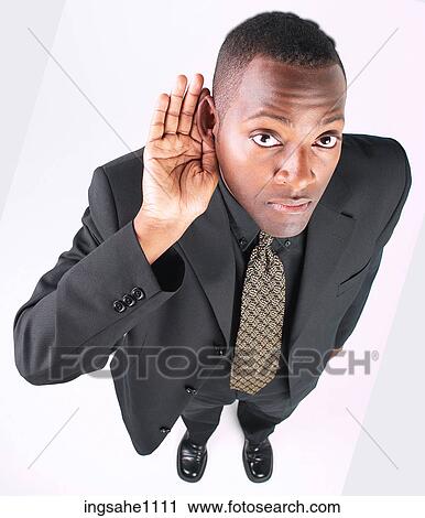 Stock Image - Businessman trying to hear a82. Fotosearch