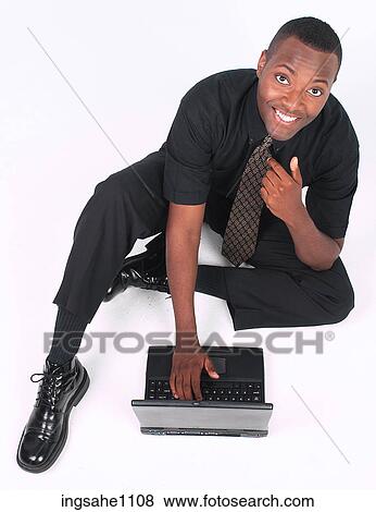 Businessman with laptop smiling View Large Photo Image Stock Photo - Businessman with laptop smiling. Fotosearch