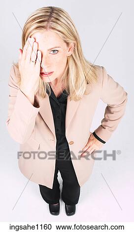 Stock Image - Businesswoman covering eye. Fotosearch