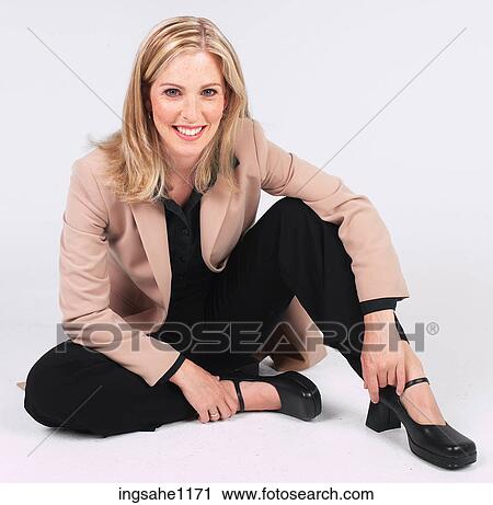 Stock Image - Businesswoman sitting casually on floor a82. Fotosearch