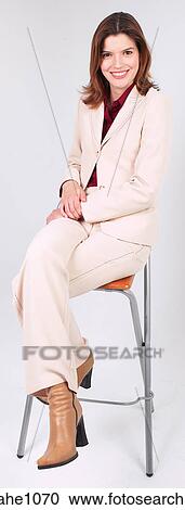 Businesswoman sitting on stool smiling a81 View Large Photo Image Stock Image - Businesswoman sitting on stool smiling a81. Fotosearch