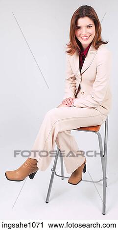 Businesswoman sitting on stool smiling a82 View Large Photo Image Stock Image - Businesswoman sitting on stool smiling a82. Fotosearch