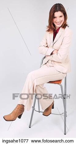 Stock Photo - Businesswoman sitting on stool smiling a86. Fotosearch