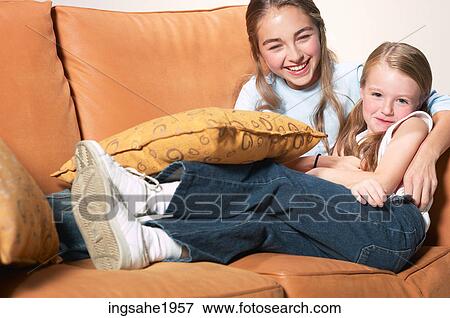 Stock Photo - Children sitting on chair BE 2. Fotosearch